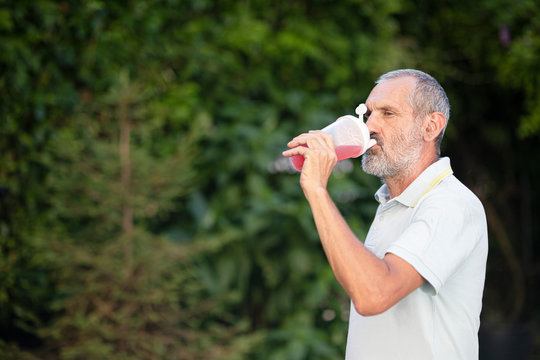 Adult man drinks vitamin supplement