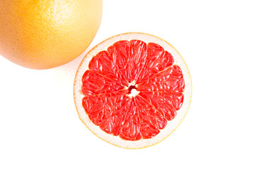 Whole and half of grapefruit isolated on white