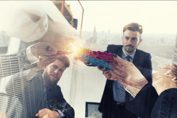 Business team connect pieces of gears. Teamwork, partnership and integration concept. double...