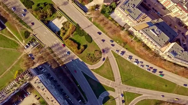 Top aerial view of traffic on elliptical road rotating