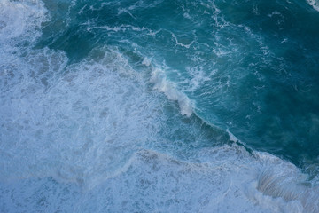 Waves crashing into seashore