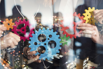 Business team connect pieces of gears. Teamwork, partnership and integration concept. double...