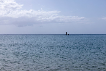 Obraz premium stand up paddle au couché du soleil