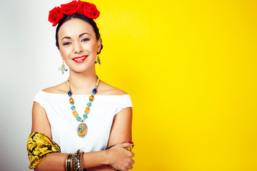 young pretty mexican woman smiling happy on yellow background, lifestyle people concept