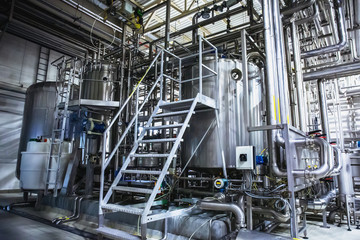 Stainless steel brewing equipment, iron reservoirs or tanks and pipes in modern beer factory....