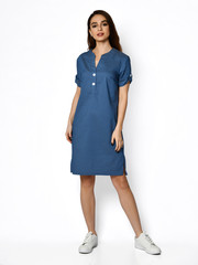 Young beautiful woman walking in new design casual summer jeans dress full body on grey 