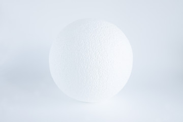 Textured white ball on a white background