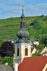 Fototapeta na wymiar Church steeple, Krems, Austria, vineyards on the hills beyond