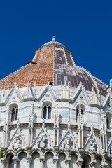 Detail of the cupola of the Pisa Baptistery of St. John against a beautiful blue sky