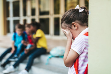 Schoolchildren isolation at primary school and bullying concept.