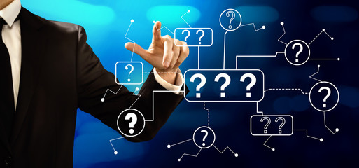 Question marks with businessman on a dark blue background