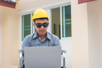 Middle-age Asian person work at home architect house building outdoor.