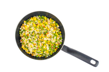 Stewed rice with corn, green peas in pan on white background. 