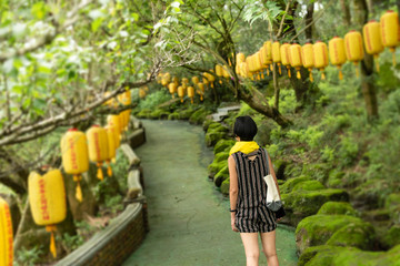 modern woman walk on a path with lanterns