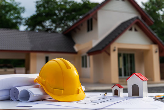 Architect Desk With Blueprint And Hard Hat Constuction Building.