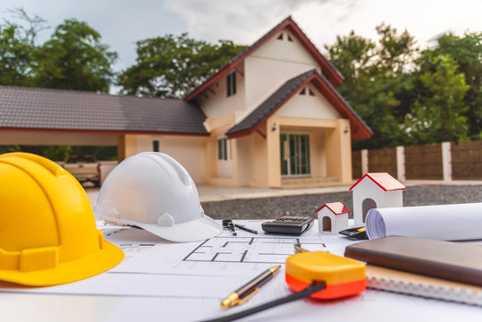 Architect Desk With Blueprint And Hard Hat Constuction Building.