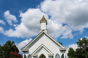 Fototapeta na wymiar Small Quaint Country Church on a Bright Sunny Day
