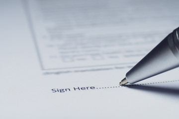 Close-up of silver pen are signing contract agreement. Contract agreement policy concept.