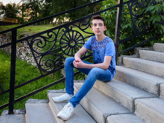 Teenage boy on stairs on the street