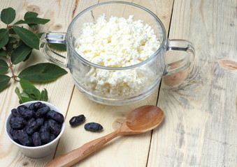 Simple rustic breakfast of honeysuckle berries and fresh cottage cheese, top view.Background from a...
