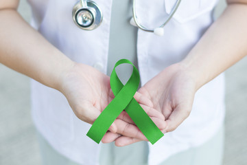 Kelly green ribbon awareness for Gallbladder and Bile Duct Cancer Awareness Month in February.