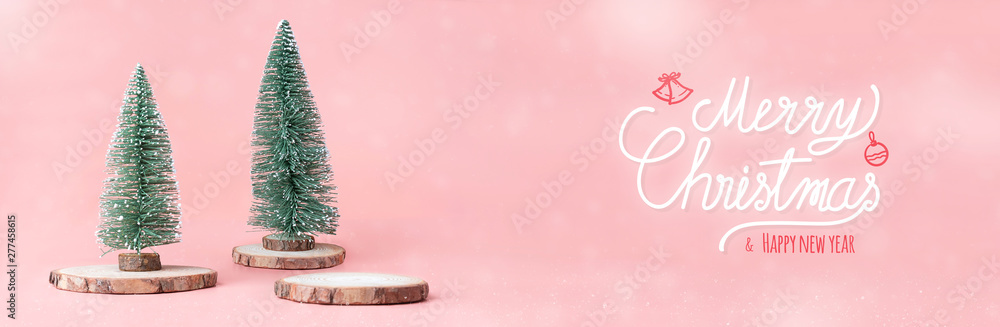 Poster merry christmas and happy new year at christmas tree on wood log slice trunks with gift box on paste