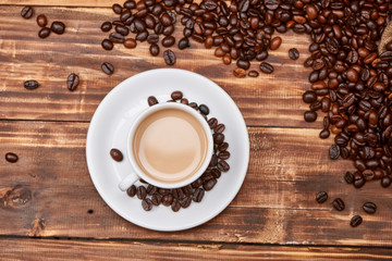 Coffee latte with coffee beans on a wooden table.
