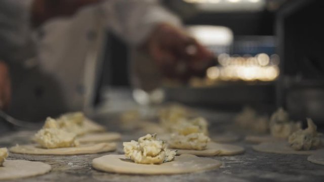 CLOSEUP footage of cooks preparing panzerotti at italian restaurant