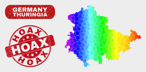 Rainbow colored dot Thuringia Land map and rubber prints. Red rounded Hoax textured stamp. Gradiented rainbow colored Thuringia Land map mosaic of random small spheres.