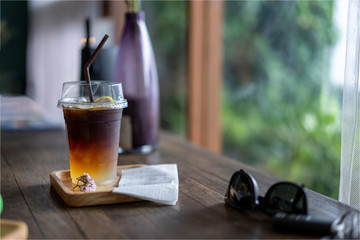Cold black coffee drinks placed on a wooden table