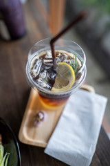 Cold black coffee drinks placed on a wooden table