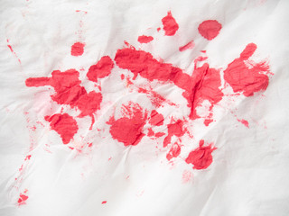 Red paint spots on white paper, close up view. Red inkblots on white background. Abstract picture. Colourful abstract background