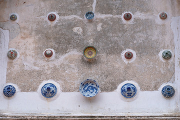 beautiful Chinaware bowls decorated on the wall of church at wat Ban Lang temple in Rayong province Thailand. the old church was built in Ayutthaya period