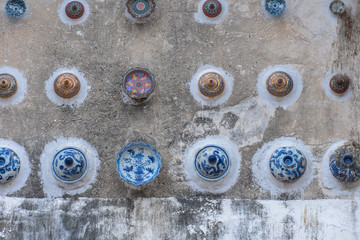 beautiful cups and bowls decorated on the wall of church at wat Ban Lang temple in Rayong province Thailand. the old church was built in Ayutthaya period