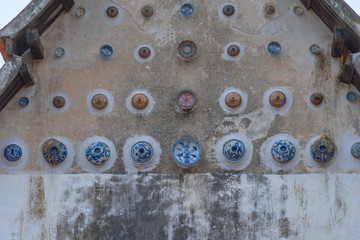 beautiful Chinaware bowls decorated on the wall of church at wat Ban Lang temple in Rayong province Thailand. the old church was built in Ayutthaya period