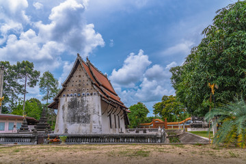 Fototapeta na wymiar white cloud in blue sky above the old church of wat Ban Lang temple in Rayong province Thailand. the old church was built in Ayutthaya period