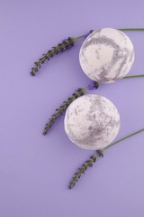 Lavender Bath Bomb.  bath bombs and sprigs of lavender on a combined lilac background.Organic  body...