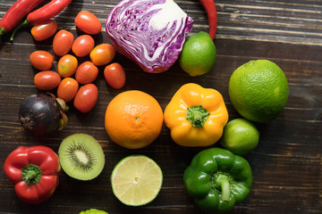 Colorful of Healthy fruit on wooden table. Chili , lemon, tomato, bell pepper, Mangosteen, Kiwi, cabbage, Multi fresh fruits on background. Royalty high quality free stock image.