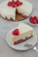 Cheesecake slice with raspberries on a plate