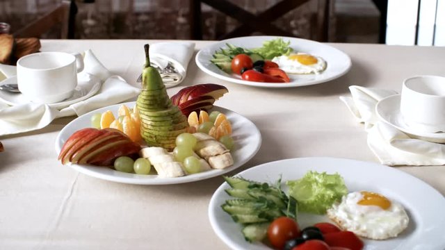 Three shot sequence of table in hotel restaurant with healthy breakfast for two