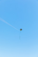 Handmade kite flying with a blue sky background