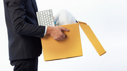 Man holding the office equipment box and his belongings on white background. Termination of...