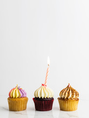 Variety Cupcakes with candle Birthday party background ,cupcake on white background 