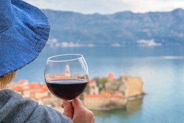 Caucasian woman drinking red wine in summer