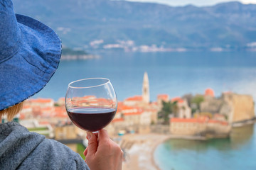 Caucasian woman drinking red wine in summer