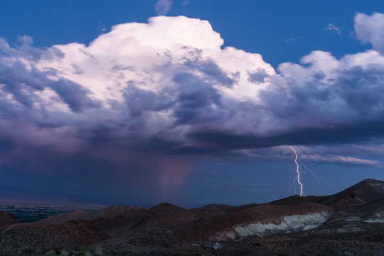 Thunderstorm with lightning stike after sunset in the desert