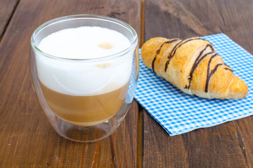 Cappuccino in glass cup with croissant for lunch. 