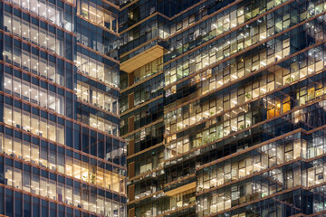 Glowing windows of skyscrapers. Modern office buildings