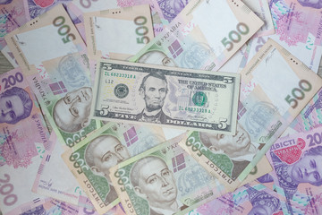 American five dollars banknote and ukrainian hryvnas. Corruption in Ukraine. Money background.
