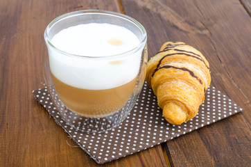 Cappuccino in glass cup with croissant for lunch. 